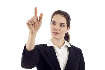 Business woman looking up and pointing at the screen isolated over white backgroundの写真素材