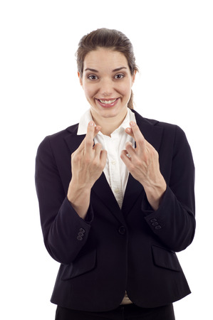 Smiling young woman hoping with fingers crossed isolated over white backgroundの写真素材