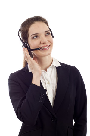 Beautiful business customer service woman - smiling and looking up isolated over whiteの写真素材
