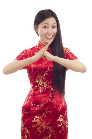 Pretty Chinese girl with cheongsam wishing you a Happy Chinese New Year!の写真素材