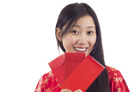 Pretty smiling Chinese woman with red envelopes. Happy Chinese New Year!の写真素材