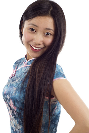 Pretty Asian woman wearing a traditional Chinese cheongsam isolated over white backgroundの写真素材