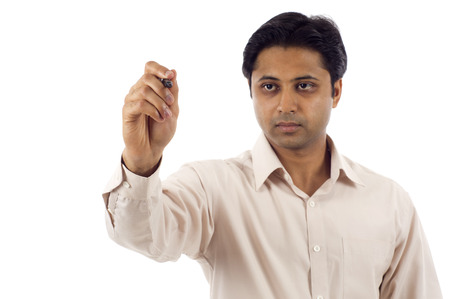 Indian business man writing on a clear screen, add your own text or drawing.の写真素材