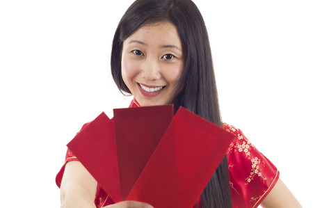 Pretty smiling Chinese woman with red envelopes. Happy Chinese New Year!の写真素材