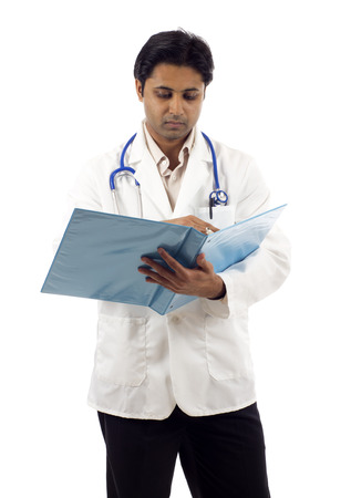 Successful young Asian doctor going through a fileの写真素材