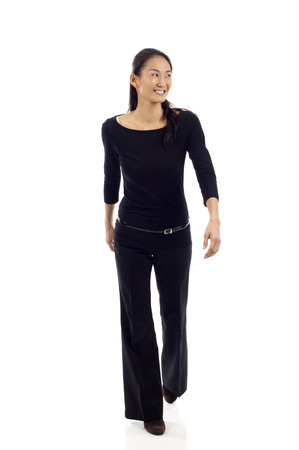 Asian businesswoman walking isolated over white backgroundの写真素材