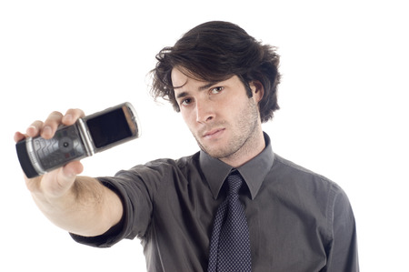 Business man showing mobile phone isolated over a white backgroundの写真素材