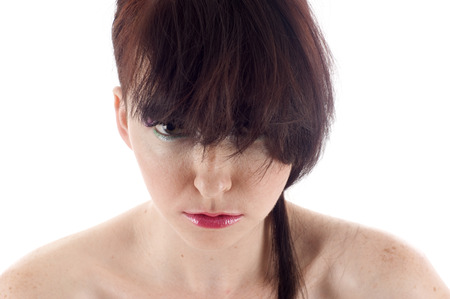 Angry rebellious young woman isolated over whiteの写真素材