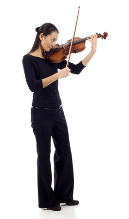 Full length of an Asian woman playing the violin isolated over white backgroundの写真素材