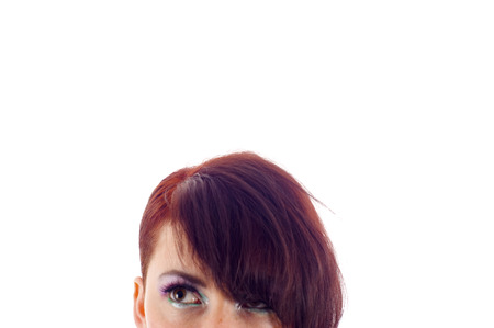 Close-up portrait of a beautiful woman looking up into the corner. Lots of copyspace and room for text on this isolate.の写真素材