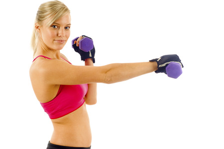 Fitness woman exercises with dumbbells isolated over white backgroundの写真素材
