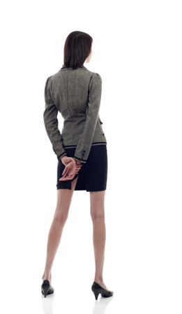 Business woman from the back - looking at something over a white backgroundの写真素材