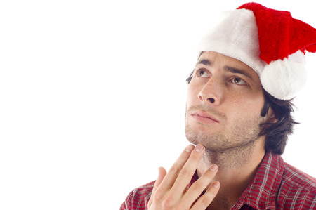 Smiling Man with Christmas Red Hat Looking Pensive -Isolated over a white  backgroundの写真素材
