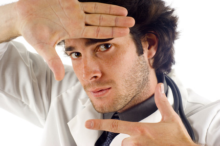 Closeup of doctor making a hand frame isolated on whiteの写真素材