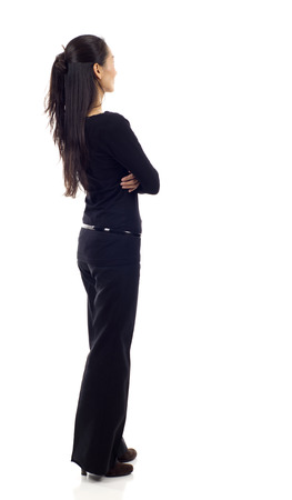Asian business woman from the back - looking at something isolated over white backgroundの写真素材