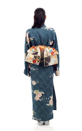 Full length back view of a Japanese kimono woman standing isolated over white backgroundの写真素材
