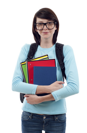 Portrait of young student with glasses holding books isolated over white backgroundの写真素材