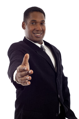 Portrait of handsome African American business man offering handshake over white backgroundの写真素材