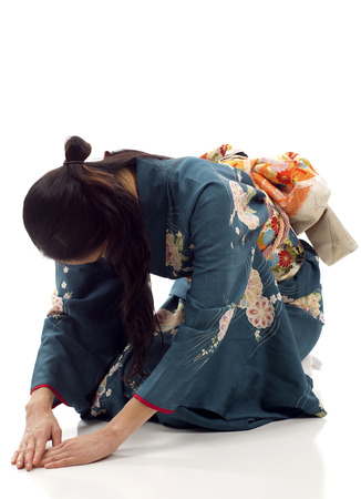 Japanese kimono woman bowing isolated over white backgroundの写真素材