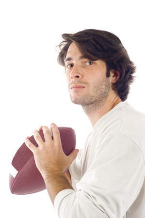 Young handsome man holding a football isolated over whiteの写真素材