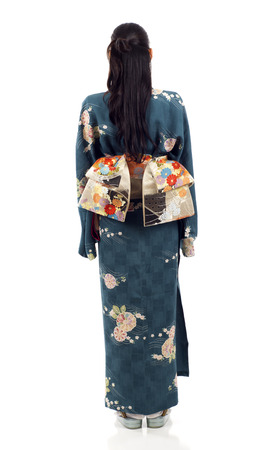 Full length back view of a Japanese kimono woman standing isolated over white backgroundの写真素材