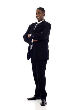 Full length of a confident African American businessman standing with his hands crossed isolated white backgroundの写真素材