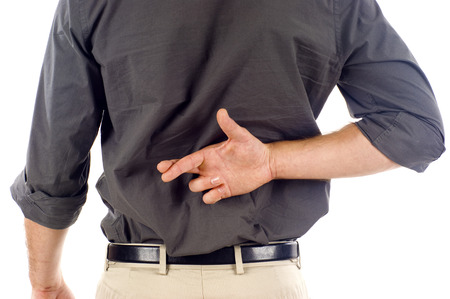 Businessmanwith crossed fingers behind his backの写真素材