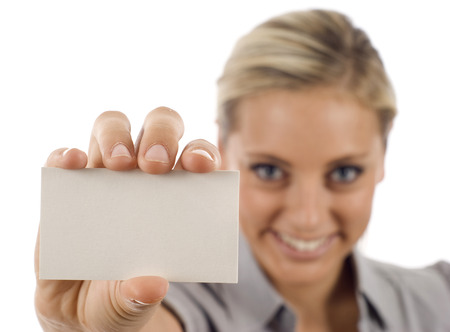 Businesswoman showing and handing a blank business card, the focus was on the business card.の写真素材