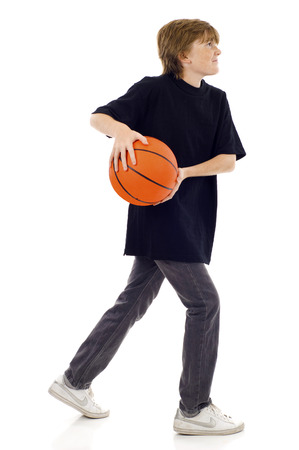 Young boy dunking a basketball isolated on white backgroundの写真素材