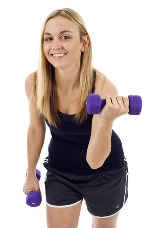 Woman working out at the gym isolated over white background.の写真素材