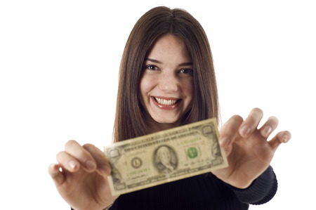 Portrait of excited young woman holding money in the hand on white background