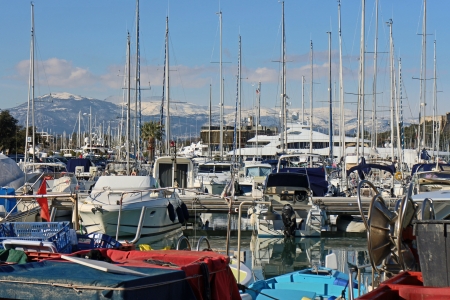 Antibes, France, 12th February, 2013, Boats in the harbour of Antibes with the snow covered alpes in the backgroundのeditorial素材