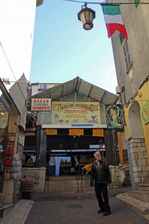 Antibes, France, 14th February, 2013, A man in his sixties infront of the entrance to Marché provencalのeditorial素材