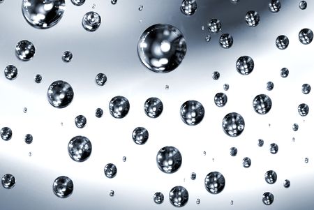 Clean water droplets on reflective surface.