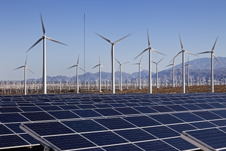 A View of Solar Panels and Wind Turbine in the Field