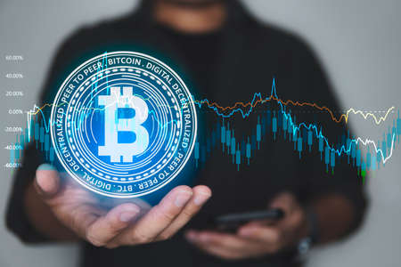 Man holding Bitcoin hologram. Cryptocurrency and finance concept.