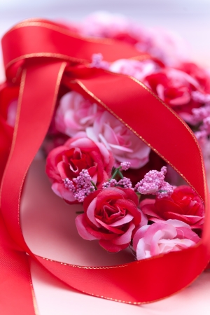 Red ribbon and Artificial flower with soft shadowsの写真素材
