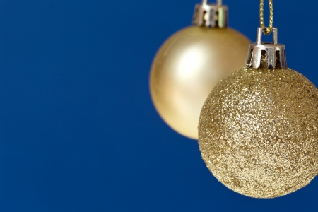 Christmas balls hanging on blue,with copy space to the left の写真素材