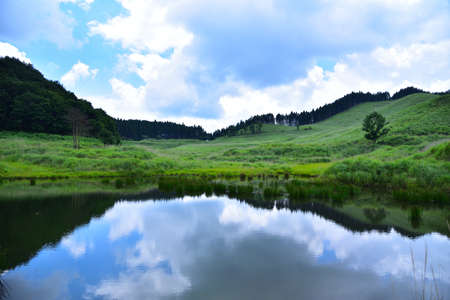 Under the blue sky, the big plateau expands. It makes us relaxed and feel good. We should care of our nature well.の写真素材