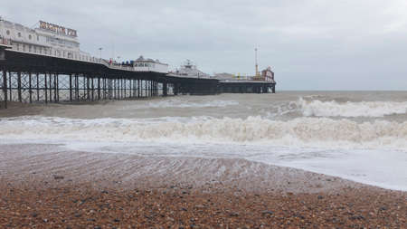 Brighton beach and  Palace Pier in stormy weather, Brighton, Englandのeditorial素材