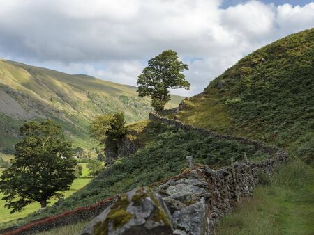 Country path along a farm wall, St John's in the Vale, Lake District National Park, Cumbria, England