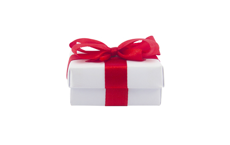 white gift box and red bow isolated on white backgrounの写真素材