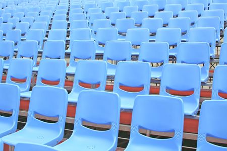 Empty blue bleachers in an open air environmentの写真素材