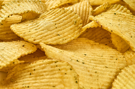 Background of juicy corrugated potato chips close-upの写真素材