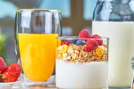 Healthy breakfast with muesli, milk, yogurt various fruitsの写真素材