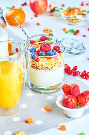 Healthy breakfast with muesli, milk, yogurt various fruitsの写真素材