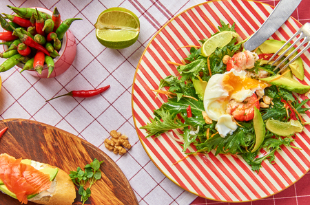 Fresh salad with arugula, shrimp and poached eggの写真素材
