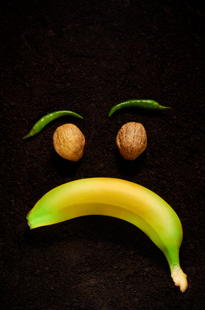 the emotion of sadness with the use of organic products of banana, nuts and pepperの写真素材