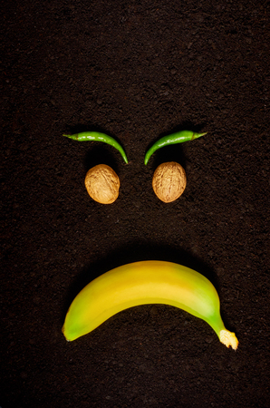 the emotion of anger using organic products of banana, nuts and pepperの写真素材