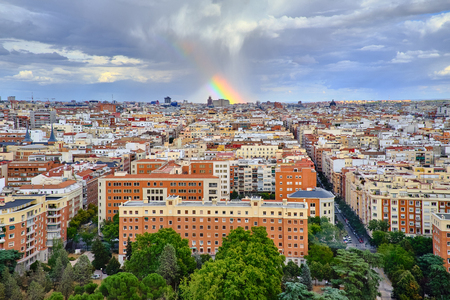 top view of the roofs of Madrid and the rainbow above them after the rainの写真素材